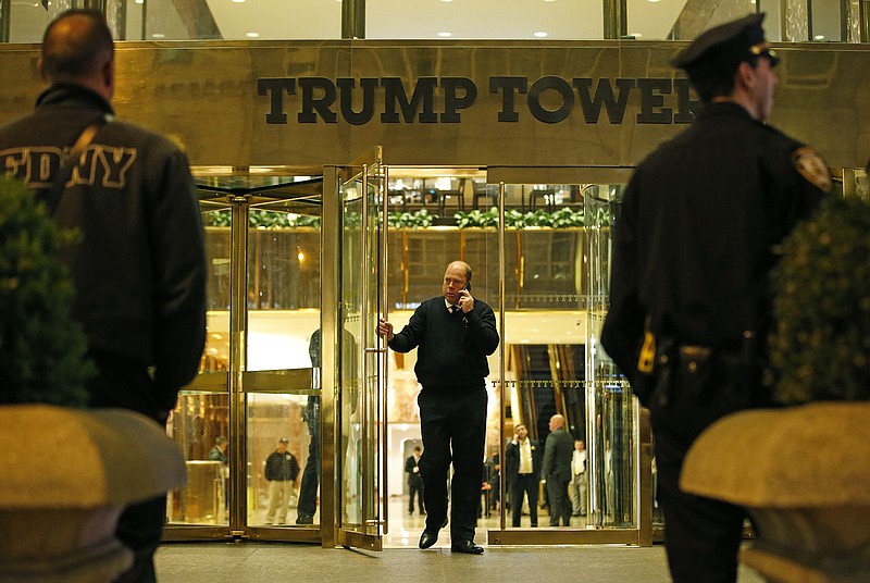 Police and fire department officers stand outside Trump Tower where detectives and other agencies were investigating a suspicious white powder found inside the building, Thursday, April 28, 2016, in New York. Six people were being evaluated by emergency medical crews after an envelope containing a white powdery substance was mailed to Republican presidential candidate Donald Trump's campaign office in New York City. Police said a Trump staffer opened the letter containing the powder and immediately called police. It was unclear if the envelope also contained a letter. 