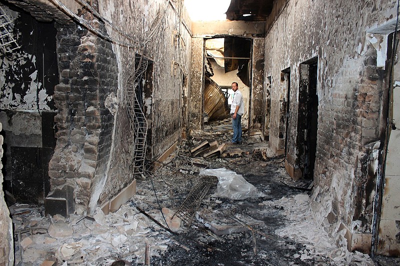 In this Oct. 16, 2015, file photo, an employee of Doctors Without Borders stands inside the charred remains of their hospital after it was hit by a U.S. airstrike in Kunduz, Afghanistan. The U.S. military is acknowledging that its airstrikes killed 20 civilians in Iraq and Syria over a five-month period that began last September. Central Command announced the results of multiple investigations of claims of civilian deaths from airstrikes aimed at Islamic State targets between Sept. 10, 2015 and Feb. 2, 2016. Six of the strikes were in Iraq and three were in Syria. 