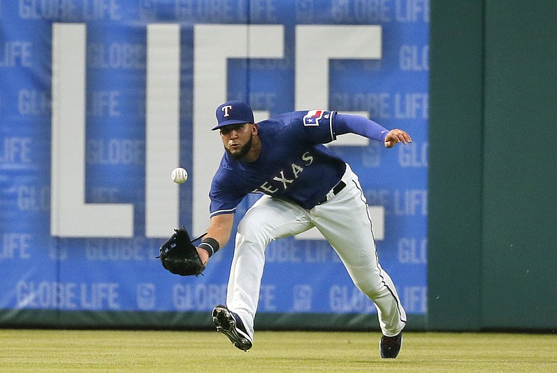 Texas Rangers right fielder Nomar Mazara reaches and makes the catch on a fly ball by Los Angeles Angels' Kole Calhoun during the fourth inning of a baseball game, Friday, April 29, 2016, in Arlington, Texas. 