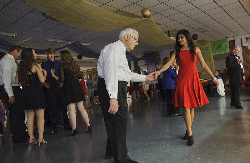 Kapital Kicks trombonist Mack McKenzie steps out from the band and shares a dance with Jefferson City High School senior Athira Nambiar during the Senior Citizens Prom. The event was hosted by the JCHS student council.