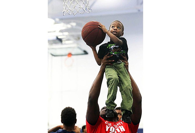 Dominique Bell, 5, shoots hoops Saturday with Cole County Youth Day volunteers in Jason Hall at Lincoln University in Jefferson City. The event invited local youth to voice their opinions on what they consider to be important issues in their lives and community.