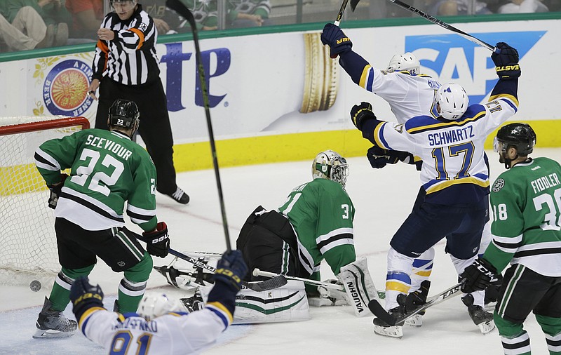 David Backes starts to celebrates his goal with Blues teammate Jaden Schwartz (17) in front of Stars goalie Antti Niemi during overtime in Sunday afternoonâ€™s game in Dallas.