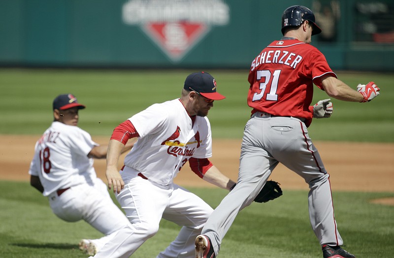 Cardinals first baseman Brandon Moss tags out Max Scherzer of the Nationals on a sacrifice bunt as starting pitcher Carlos Martinez gets out of the way during the sixth inning of Sunday afternoonâ€™s game at Busch Stadium.