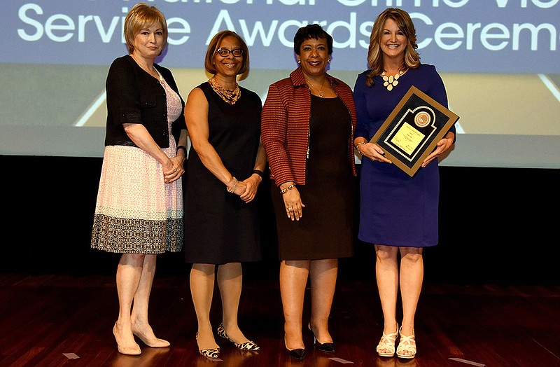 Kim Case, Missouri Sheriff's Association victim advocate, stands with (from left) Joye E. Frost, director of the Office for Victims of Crime; Assistant Attorney General Karol V. Mason; U.S. Attorney General Loretta Lynch, at an awards ceremony earlier this month in Washington, D.C. Case was honored with the Special Courage Award for her work serving victims after her own victimization in 1990.