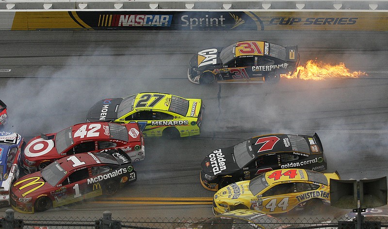 Flames trail from the car of Ryan Newman (31) as he tries to avoid a pileup of crashing cars Sunday at Talladega Superspeedway in Talladega, Ala.
