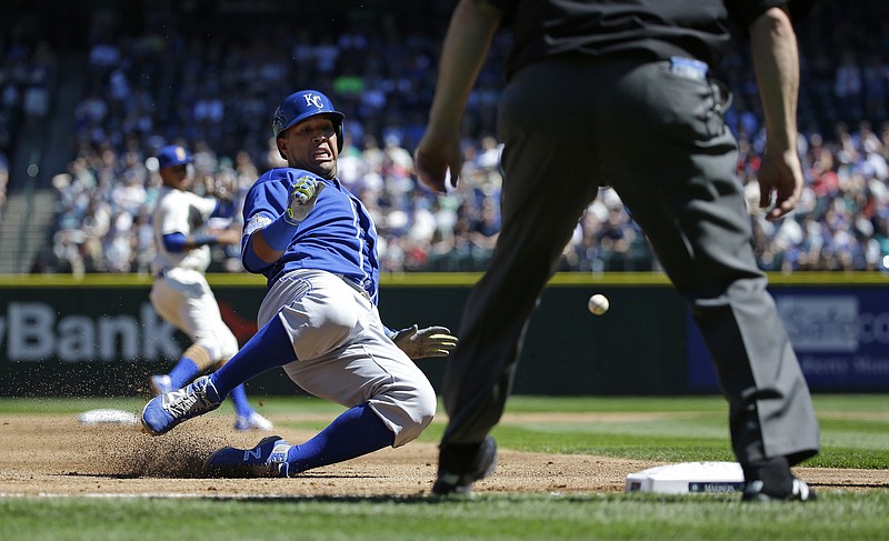 Salvador Perez of the Royals slides safely into third base as he advances on a single by Omar Infante in the second inning of Sunday afternoonâ€™s game against the Mariners in Seattle.