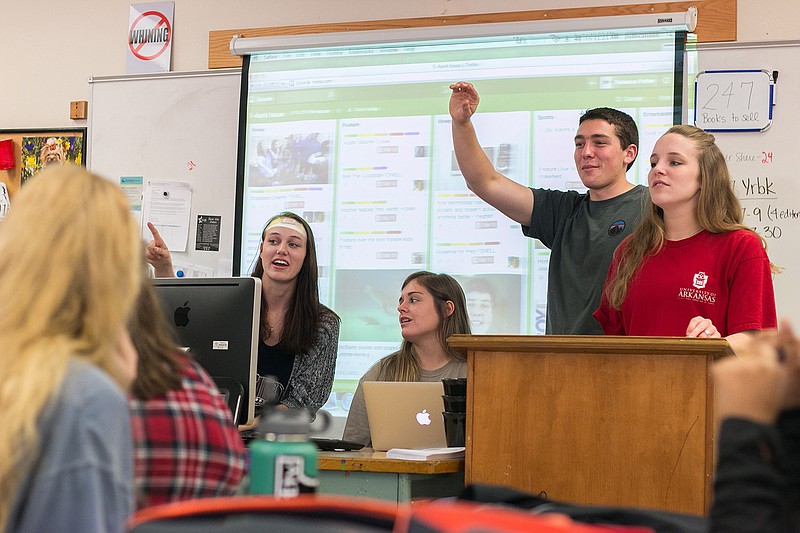 Flanked by the other editors In chief, Texas High School senior Tyler Snell answers a staff writer's question during a budget meeting. Texas High's Publications Department recently won several awards for the yearbook and print/online versions of The Tiger Times.