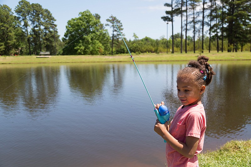 Kaylin Ward, 5, reels in a fish from Lake Dieffenbacher on Sunday, May 1, 2016 at Bobby F. Ferguson Park. She and her mother, Beverly Ward, have fished together as long as Kaylin can remember. 