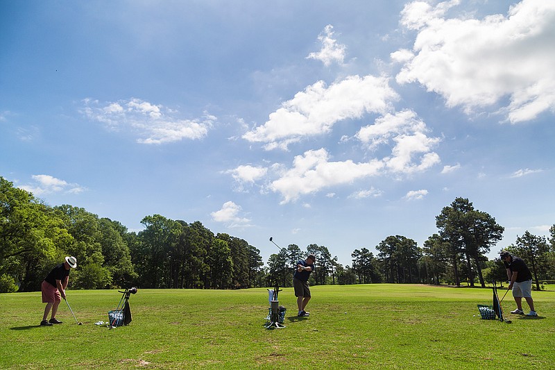 Jodie Baker, Chad Jordan and Steve Greener practice golf Saturday, April 30, 2016 before a game at Texarkana Country Club. "It is a beautiful day, especially after all that rain," Jordan said. 