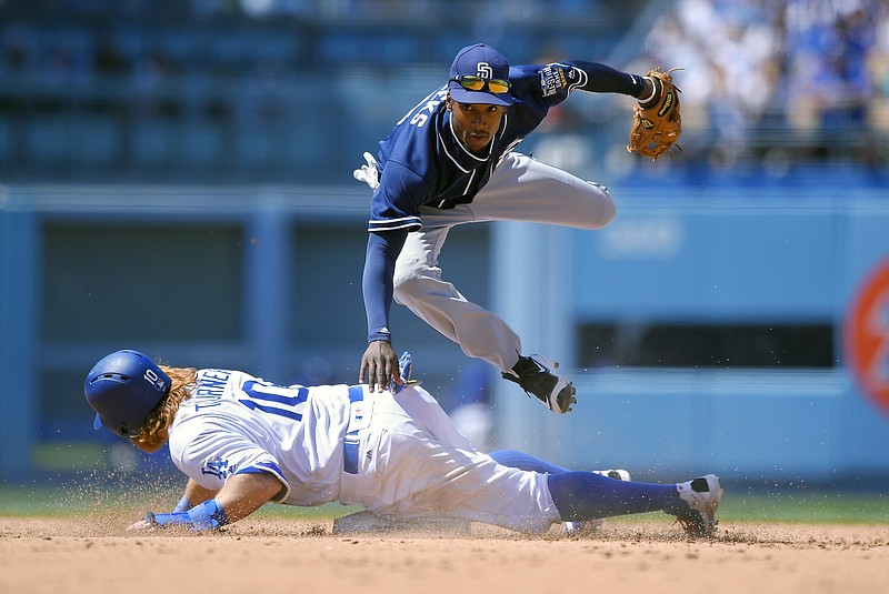 Los Angeles Dodgers' Justin Turner, below, is forced out at second as San Diego Padres second baseman Jemile Weeks throws out Howie Kendrick at first during the seventh inning of a baseball game, Sunday, May 1, 2016, in Los Angeles. 