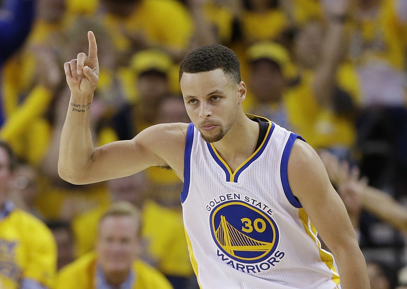 Golden State Warriors' Stephen Curry celebrates after scoring against the Houston Rockets during the first half in Game 1 of a first-round NBA basketball playoff series Saturday, April 16, 2016, in Oakland, Calif. 