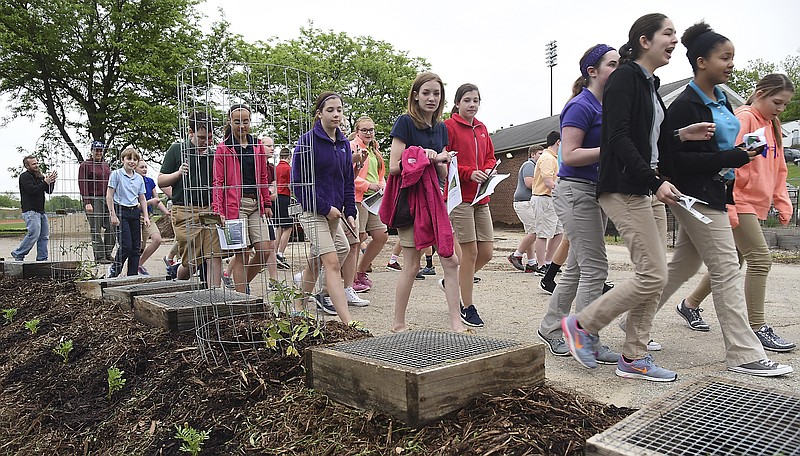 Seventh grade students from Trinity Lutheran School walk past a variety of plants on their visit to Lincoln University's Dickinson Research Center on Monday to learn about gardening. 