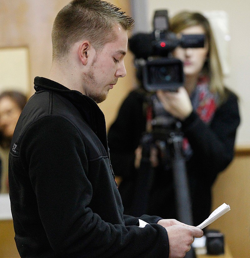 In this Dec. 19, 2013 photo, Corey Breininger reads a victim impact statement in the sentencing of his stepmother, Judith Hawkey, in the death of his father, Robert Breininger, in the Defiance County Common Pleas Court in Defiance, Ohio. Now a court ruling is raising questions once again about what took place, ordering a new trial for Hawkey, who's serving a life sentence in a shooting that has been surrounded by mystery from almost from the moment it happened.
