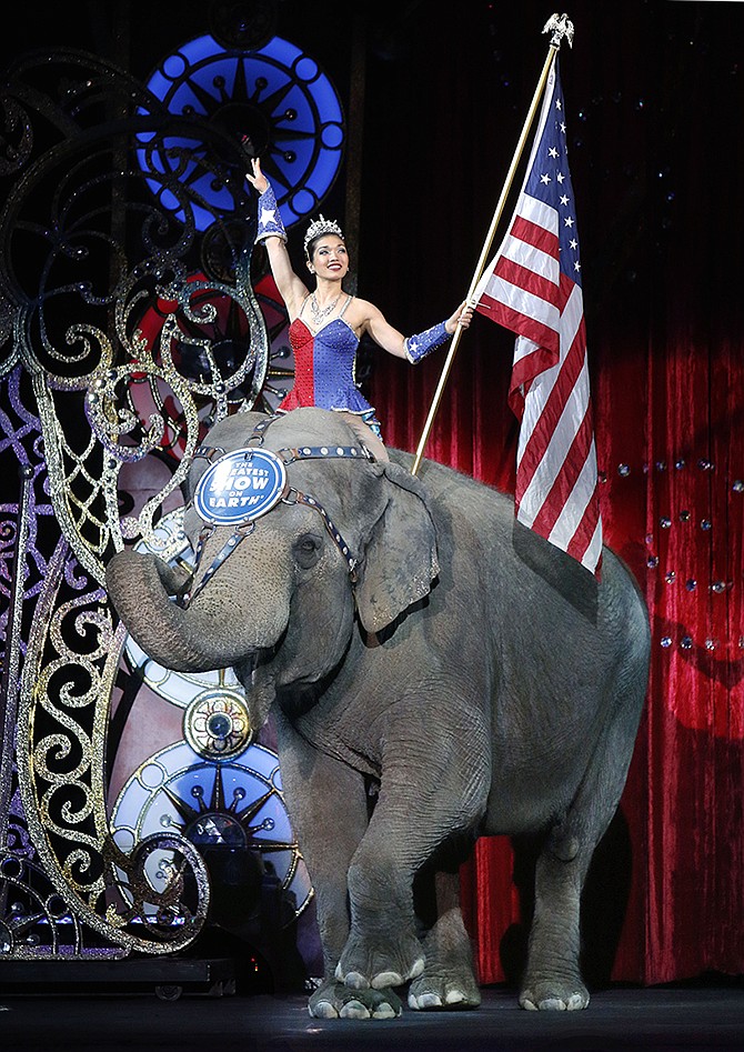 An Asian elephant performs during the national anthem for the final elephant performance Sunday during the Ringling Bros. and Barnum & Bailey Circus in Providence, Rhode Island. 