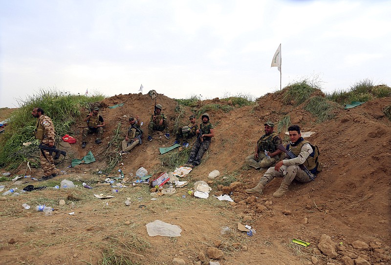 Iraqi Security forces and allied Popular Mobilization forces take combat positions during a military operation to regain control of Islamic State group held town of Besher outside the oil-rich city of Kirkuk, 180 miles north of Baghdad, Iraq.