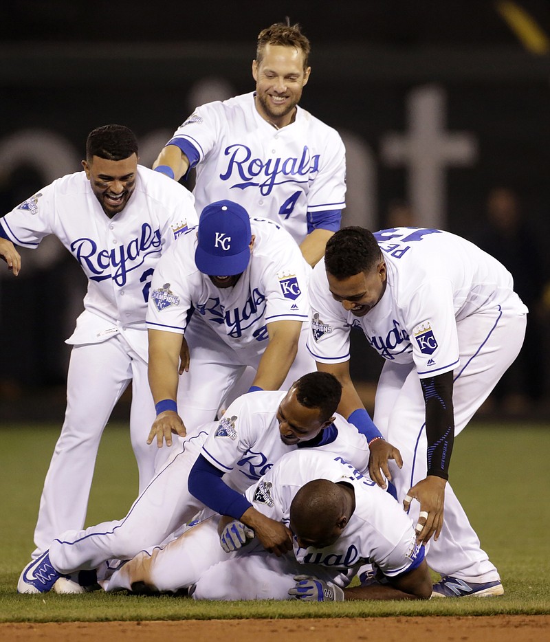 Royals players pile on Lorenzo Cain as they celebrate his game-winning RBI in the bottom of the ninth inning of Tuesday nightâ€™s game against the Nationals at Kauffman Stadium.