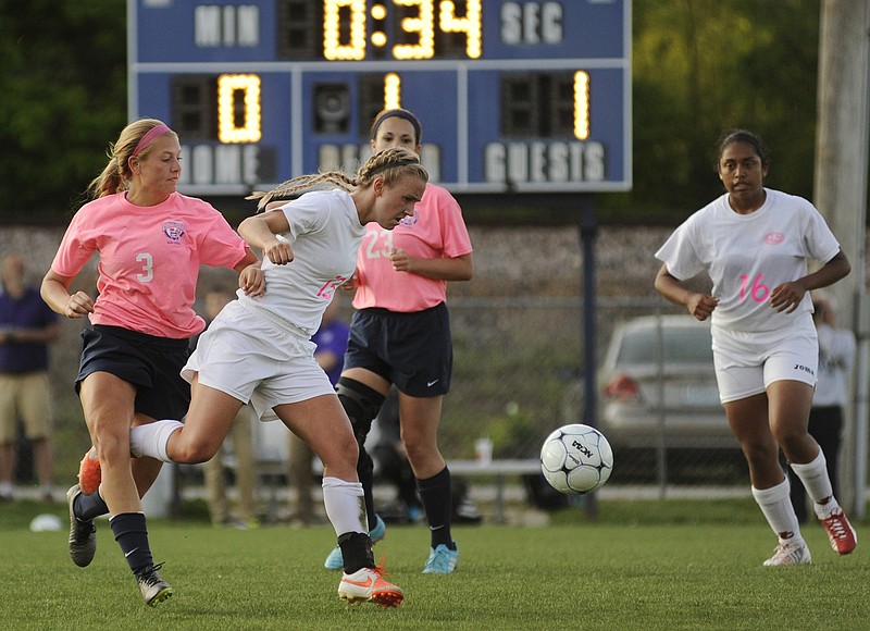 Jefferson Cityâ€™s Katie Tambke fights through the defense of Heliasâ€™ Abby Shepard during Wednesday nightâ€™s action at the 179 Soccer Park.