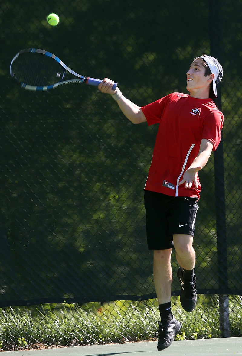 Joey Mendez of jefferson City reaches to make a return during Thursdayâ€™s dual against Helias at Washington Park.