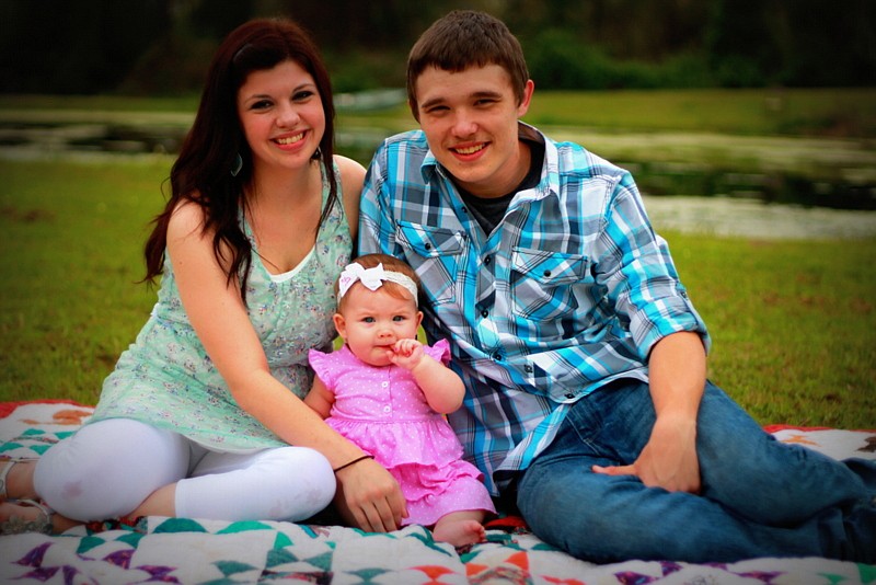 Jesse Hamilton, right, seen with wife Anna and daughter Ainsley, was killed last year.