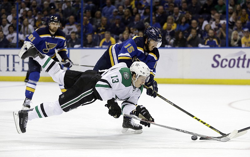 Mattias Janmark of the Stars goes flying as he reaches for a puck along side Robby Fabbri of the Blues during the third period of Thursday nightâ€™s game in St. Louis.