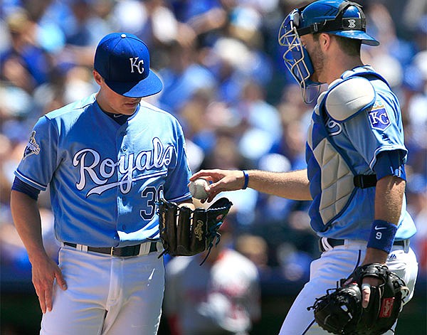 Kansas City Royals catcher Drew Butera, right, hands the ball to starting pitcher Kris Medlen (39) during the first inning of a baseball game against the Washington Nationals at Kauffman Stadium in Kansas City, Mo., Wednesday, May 4, 2016. The Royals committed three errors and allowed six run in the first inning.