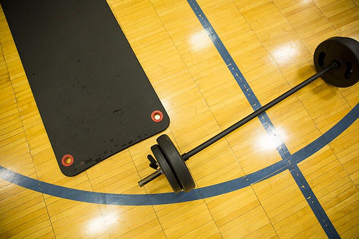 A weight set and workout mat sit on the floor of a Jefferson City YMCA facility.