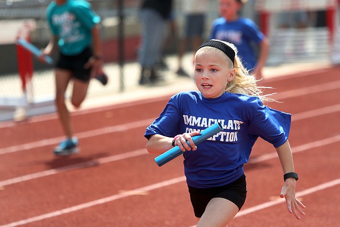 Gracie Bullock, 9, races in the relay event Saturday, May 7, 2016, during the Jefferson City Area YMCA's Little Olympics, held at Jefferson City High School. The event featured races such as the 40-yard dash, 60-yard dash, 240-yard shuttle, 300-yard shuttle, 440-yard run, ball throw and broad jump.