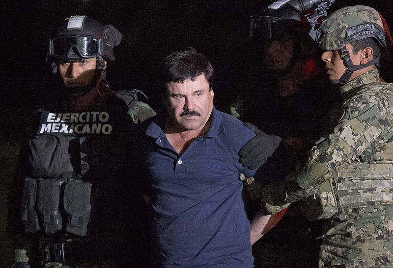 In this Jan. 8, 2016 file photo, Mexican drug lord Joaquin "El Chapo" Guzman is escorted by army soldiers  to a waiting helicopter, at a federal hangar in Mexico City, after he was recaptured from breaking out of a maximum security prison in Mexico. The History channel says it's developing a drama series focusing on Guzman's story. Last year, Guzman had broken out of prison and was on the run when he had a secret meeting with Mexican actress Kate del Castillo and Sean Penn. The actor wrote about it for Rolling Stone. 