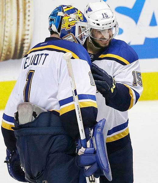 St. Louis Blues goalie Brian Elliott (1) and center Robby Fabbri (15) congratulate each other after Game 5 of the NHL hockey Stanley Cup Western Conference semifinals against the Dallas Stars, Saturday, May 7, 2016, in Dallas.