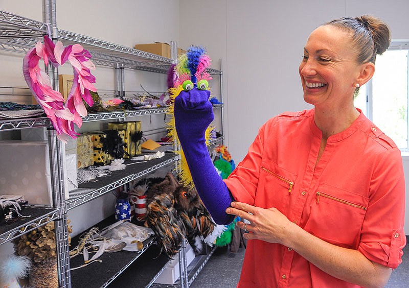 Abby Arauz has worked with her team of long-time Arkansas Valley Feather Company employees to develop new uses and finished products for their custom-dyed feathers. Children's crafts like this sock puppet are among many do-it-yourself projects the company has developed.