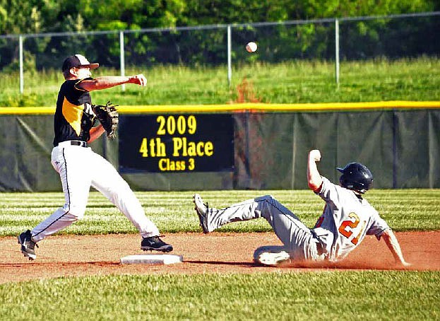 Fulton junior second baseman Luke Gray starts a double play during the Hornets' 17-7 NCMC romp over the Kirksville Tigers on Tuesday night at the high school athletic complex.