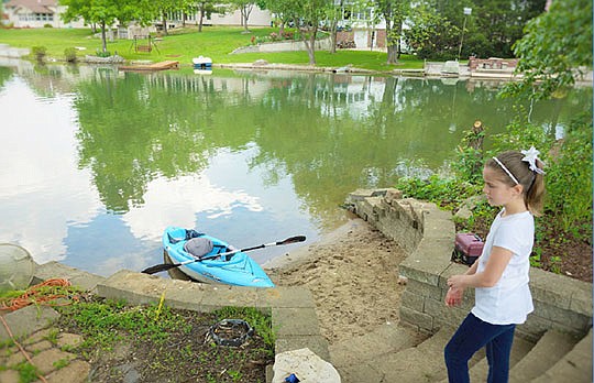 In this May 2016 photo, Lake Mykee resident Savannah Horton,10, stands on the banks of Lake Mykee.