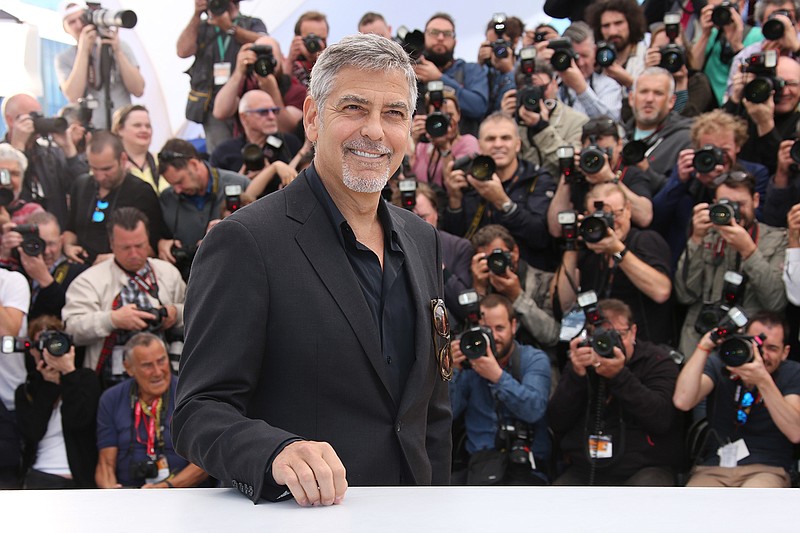 Actor George Clooney poses for photographers during a photo call for the film Money Monster at the 69th international film festival, Cannes, southern France, Thursday, May 12, 2016. 