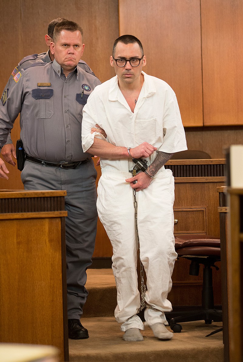 A shoeless Billy Joel Tracy is escorted into the courtroom Friday, May 13, 2016 for a pretrial hearing in New Boston, Texas. Tracy has been charged in the beating death of a Telford Prison guard in July 2015.