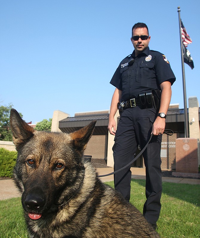 K-9 officer Chopper sits for a portrait Thursday with JCPD officer Jeremy Bowman outside the police station. Chopper is new to the station and will work with Bowman.