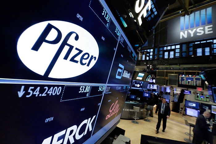 This April 6, 2016, file photo shows the Pfizer logo appearing on a screen above its trading post on the floor of the New York Stock Exchange. 