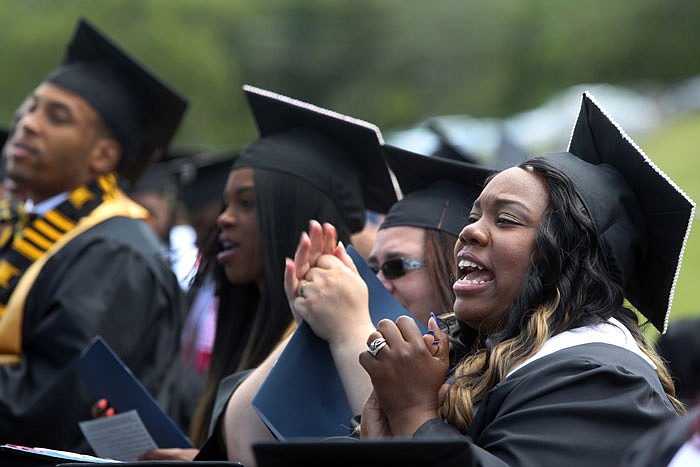 Nicole Lee, right, reacts Saturday during the 2016 commencement ceremonies held at Lincoln University. Lee graduated with a degree in liberal studies with her husband, Raymond Lee.