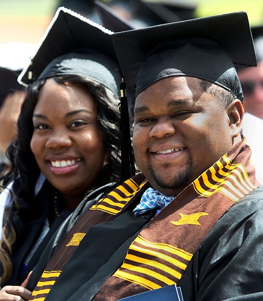 Nicole Lee, left, poses for a picture Saturday with her husband Raymond Lee during commencement ceremonies held at Lincoln University in Jefferson City.