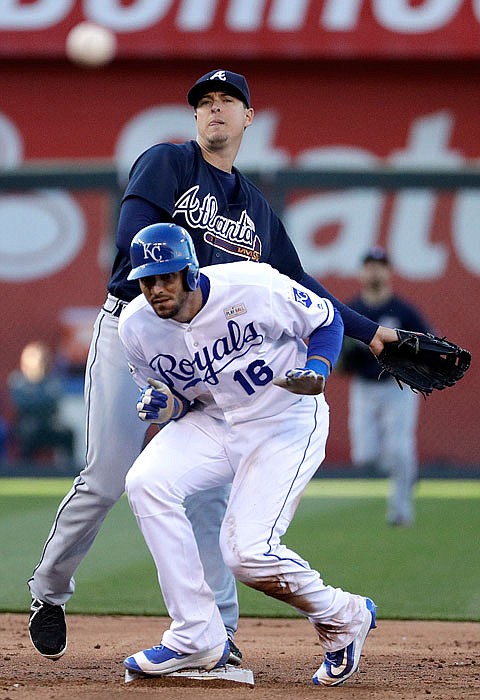 Atlanta Braves second baseman Kelly Johnson watches his throw to first for the double play hit into by Kansas City Royals' Lorenzo Cain after forcing Paulo Orlando (16) out at second during the third inning of a baseball game Saturday, May 14, 2016, in Kansas City, Mo. 