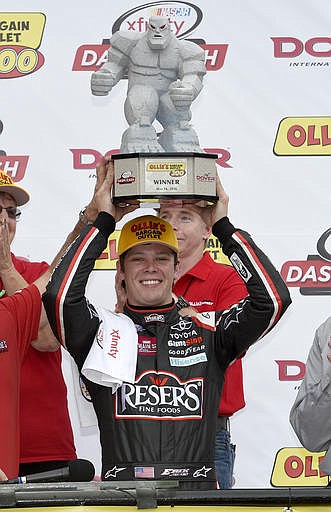 Erik Jones celebrates his win in Victory Lane as he poses with the trophy after the NASCAR Xfinity series auto race, Saturday, May 14, 2016, at Dover International Speedway in Dover, Del.
