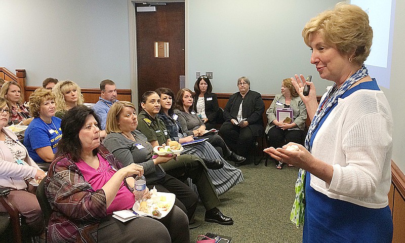 This Wednesday May 11, 2016 photo shows Andrea Darr, director of the West Virginia Center for Children's Justice speaking at the Mercer County Family Court to school officials and law enforcement agencies about the program, "Handle With Care" in Princeton W.Va. A new program being organized in Mercer County could give teachers notice when one of their students needs to be handled with care. 