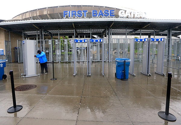 A security workers puts away screening equipment after Monday's game between the Boston Red Sox and Kansas City Royals was postponed in Kansas City.