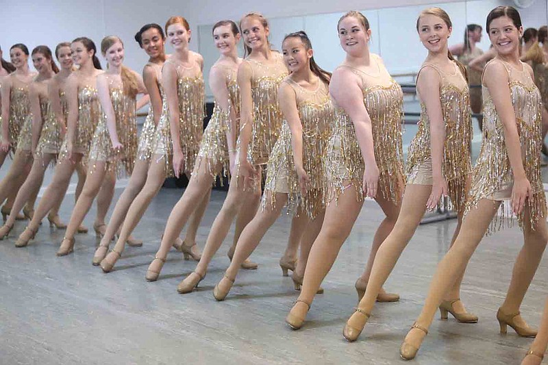 Dancers finish in their final pose during a rehearsal of "X's and O's" by the advanced tap group of Dancers' Alley. Dancers' Alley recital premieres May 28.