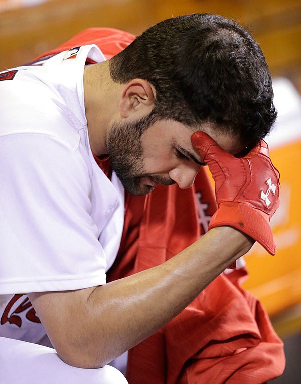 Cardinals starting pitcher Jaime Garcia sits in the dugout after being pulled for a pinch-hitter during the fifth inning of Tuesday night's game against the Rockies at Busch Stadium.