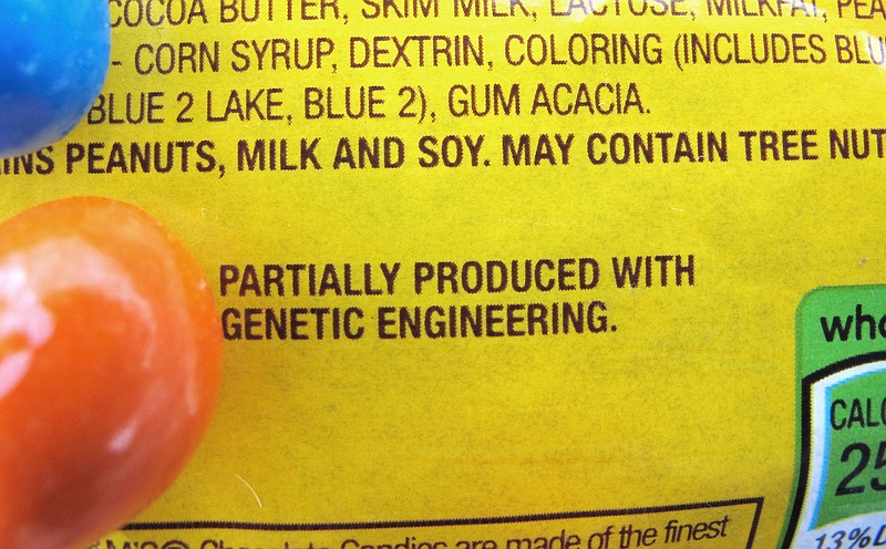 A new disclosure statement is displayed on a package of Peanut M&M's candy in Montpelier, Vermont, saying they are "Partially produced with genetic engineering." Genetically manipulated food remains generally are safe for humans and the environment, a high-powered science advisory board declared in a report Tuesday.