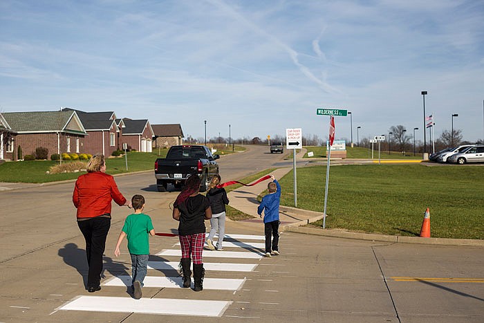 In this Nov. 24, 2015, file photo, students walk along a sidewalk near Pioneer Trail Elementary School.