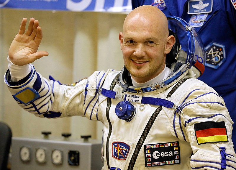 In this May 28, 2014 file photo European Space Agency's astronaut Alexander Gerst, crew member of the mission to the International Space Station, ISS, waves during inspection of his space suit prior to the launch of the Soyuz-FG rocket at the Russian leased Baikonur cosmodrome, Kazakhstan. 