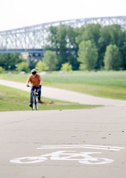 This Aug. 19, 2011 file photo shows a road surface marking which points riders coming from the Katy Trail toward the pedestrian/bike lane crossing the Missouri River in north Jefferson City.