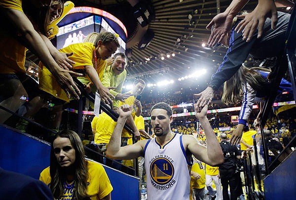 The Warriors' Klay Thompson shakes hands with fans as he walks off the court after Game 5 against the Portland Trail Blazers in the NBA Western Conference finals.