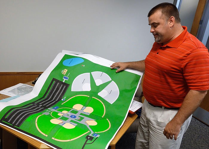 Clay Caswell, Fulton Parks and Recreation Director, looks at a rendering of the new baseball complex.